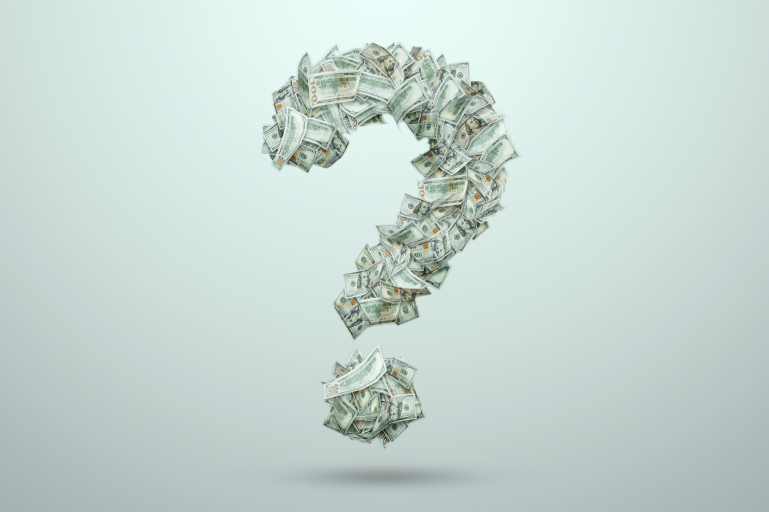 A question mark made of one hundred dollar bills. The concept of investment in a new business, new beginnings, purchases.