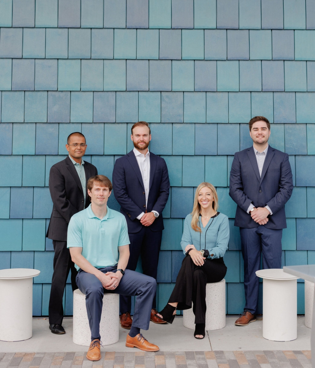 Polaris Healthcare team posing against a tiled building